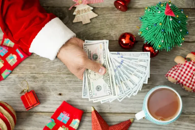 santa-claus-hand-holding-cash-money-against-christmas-background-suggesting-high-expenses-holidays-132630224